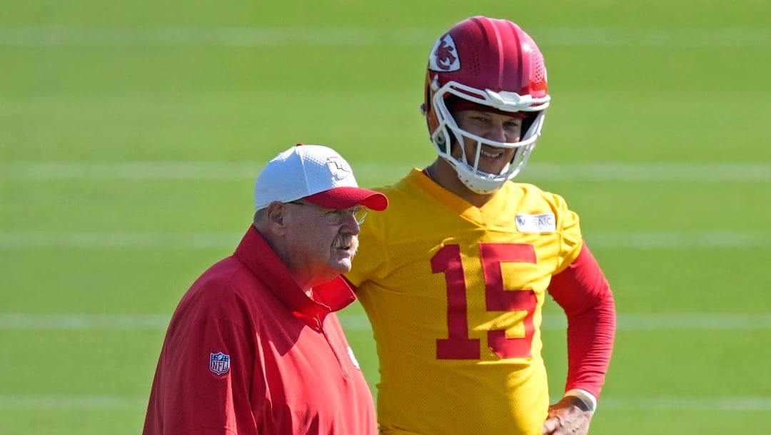 Kansas City Chiefs head coach Andy Reid and quarterback Patrick Mahomes watch practice at NFL football training camp Wednesday, July 17, 2024, in St. Joseph, Mo. (AP Photo/Charlie Riedel)