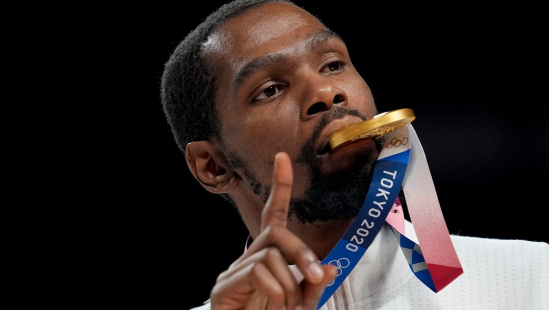 FILE - Kevin Durant poses for a photo with his gold medal during the medal ceremony for basketball game at the 2020 Summer Olympics, Aug. 7, 2021, in Tokyo, Japan.