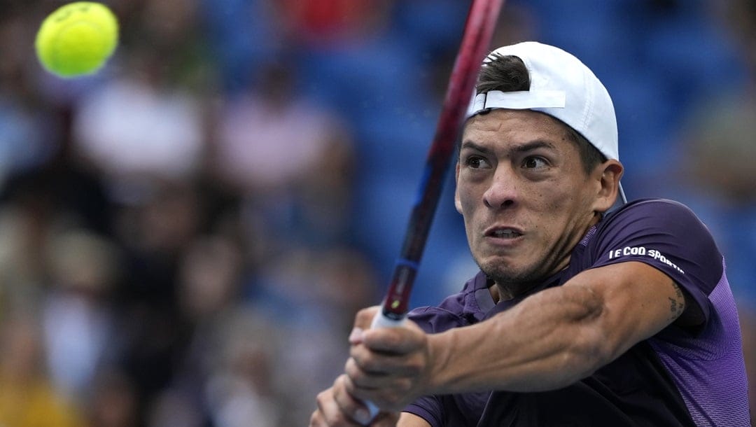 Sebastian Baez of Argentina plays a backhand return to Jannik Sinner of Italy during their third round match at the Australian Open tennis championships at Melbourne Park, Melbourne, Australia, Friday, Jan. 19, 2024.