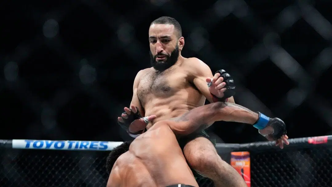 Belal Muhammad, right, knees Brazil's Gilbert Burns during the first round of a welterweight bout at the UFC 288.