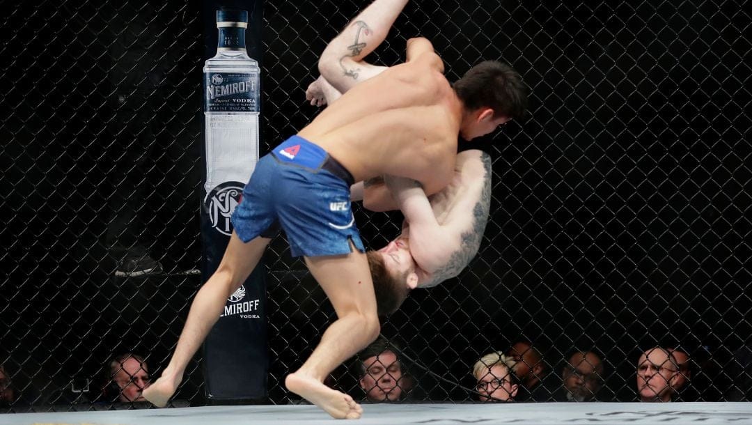 Mario Bautista slams Cory Sandhagen to the mat during the first round of a bantamweight mixed martial arts bout at UFC Fight Night.