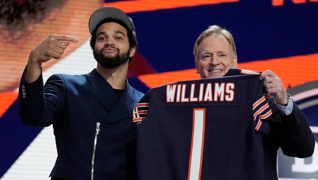 Southern California quarterback Caleb Williams celebrates with NFL commissioner Roger Goodell after being chosen by the Chicago Bears with the first overall pick during the first round of the NFL football draft, Thursday, April 25, 2024, in Detroit. (AP Photo/Jeff Roberson)