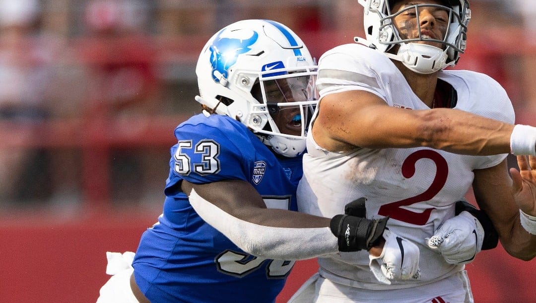 Buffalo's C.J. Bazile (53) tackles Nebraska quarterback Adrian Martinez (2) as he attempts to make a pass during the second half of an NCAA college football game, Saturday, Sept. 11, 2021, at Memorial Stadium in Lincoln, Neb. (AP Photo/Rebecca S. Gratz)