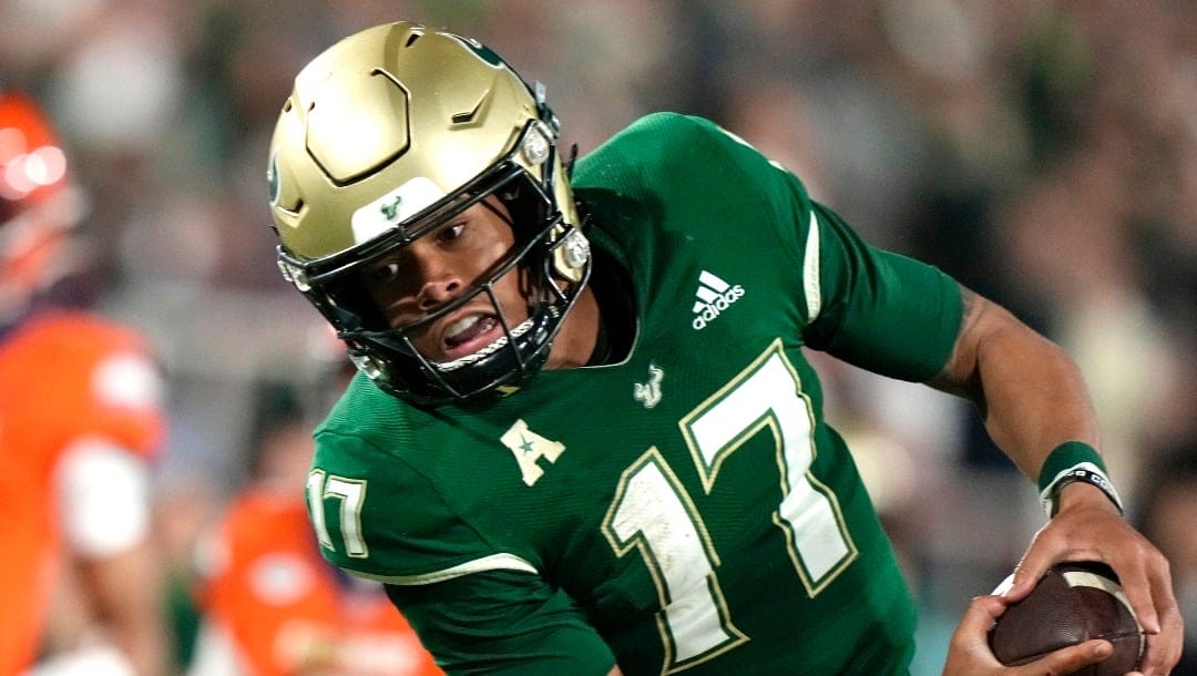 South Florida quarterback Byrum Brown (17) runs for a first down during the second half of the Boca Raton Bowl NCAA college football game against Syracuse, Thursday, Dec. 21, 2023, in Boca Raton, Fla. (AP Photo/Lynne Sladky)