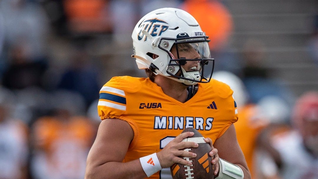 UTEP quarterback Cade McConnell (11) rolls out looking for an open receiver during the first half of an NCAA college football game against Liberty on Saturday, Nov. 25, 2023, in El Paso, Texas. (AP Photo/Andres Leighton)