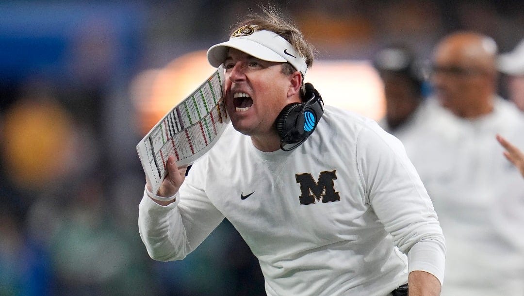 Missouri head coach Eliah Drinkwitz yells during the second half of the team's Cotton Bowl NCAA college football game against Ohio State on Friday, Dec. 29, 2023, in Arlington, Texas. (AP Photo/Julio Cortez)