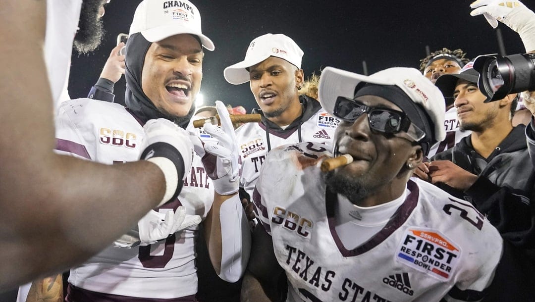 Texas State running back Ismail Mahdi (21) celebrates with teammates after their 45-21 win over Rice in the First Responder Bowl NCAA college football game Tuesday, Dec. 26, 2023, in Dallas.