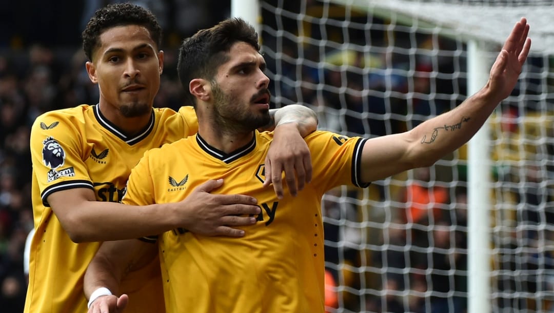 Wolverhampton Wanderers' Pedro Neto, right, celebrates after scoring his side's opening goal during the English Premier League soccer match between Wolverhampton Wanderers and Manchester City at the Molineux Stadium in Wolverhampton, England, Saturday, Sept. 30, 2023.