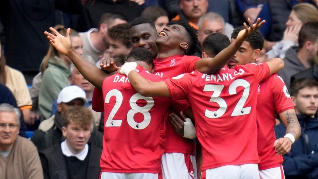 Nottingham Forest's Taiwo Awoniyi, center, celebrates after scoring the opening goal during the English Premier League soccer match between Chelsea and Nottingham Forest at Stamford Bridge stadium in London, Saturday, May 13, 2023.