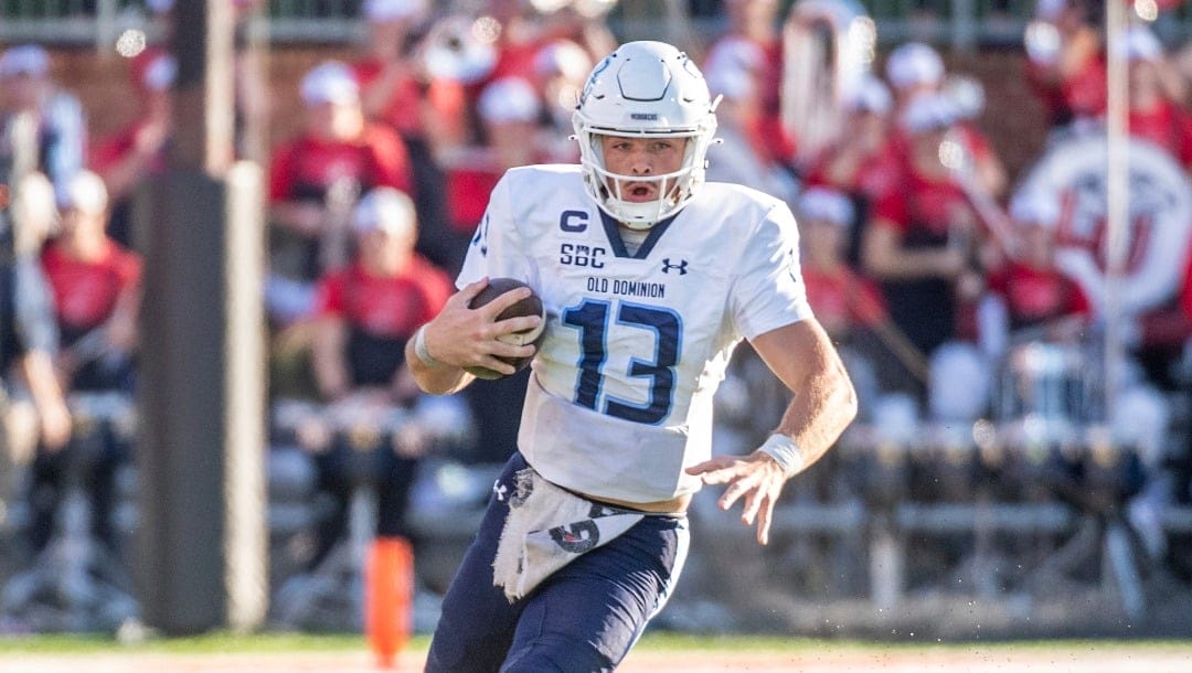 Old Dominion's Grant Wilson (13) runs the ball against Liberty during the second half an NCAA college football game, Saturday, Nov. 11, 2023, in Lynchburg, Va. (AP Photo/Robert Simmons)