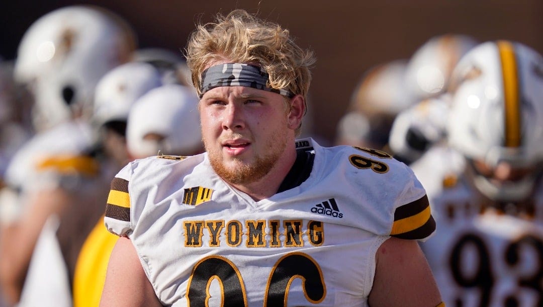 Wyoming defensive tackle Jordan Bertagnole walks the sidelines during an NCAA college football game against Illinois Sunday, Aug. 28, 2022, in Champaign, Ill. (AP Photo/Charles Rex Arbogast)