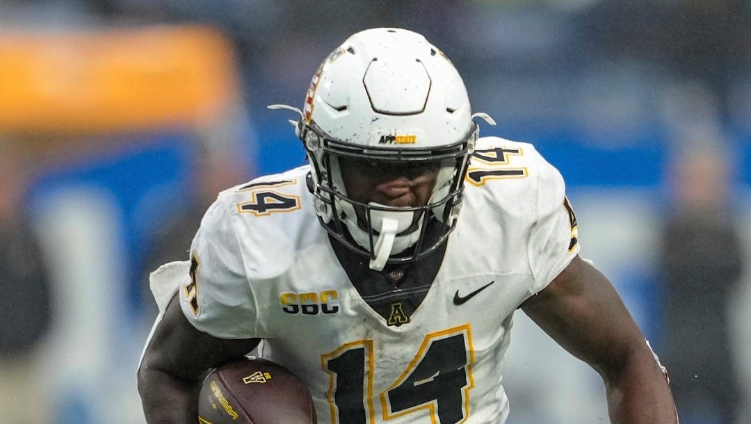 Appalachian State running back Kanye Roberts (14) runs towards the corner of the endzone during an NCAA football game on Saturday, Nov. 11, 2023, in Atlanta. (AP Photo/Jason Allen)