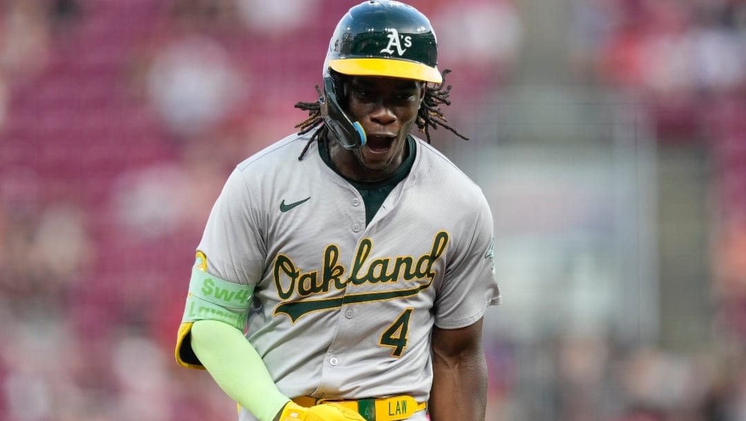 Oakland Athletics' Lawrence Butler celebrates as he rounds the bases after hitting a home run during the ninth inning of a baseball game against the Cincinnati Reds, Thursday, Aug. 29, 2024, in Cincinnati.