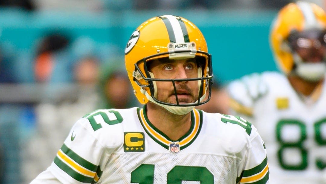 Green Bay Packers quarterback Aaron Rodgers (12) watches a replay during an NFL football game against the Miami Dolphins, Sunday, Dec. 25, 2022, in Miami Gardens, Fla. (AP Photo/Doug Murray)