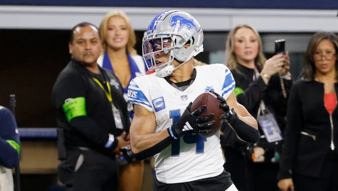 Detroit Lions wide receiver Amon-Ra St. Brown (14) makes a touchdown reception during an NFL football game in Arlington, Texas, Saturday, Dec. 30, 2023. (AP Photo/Michael Ainsworth)