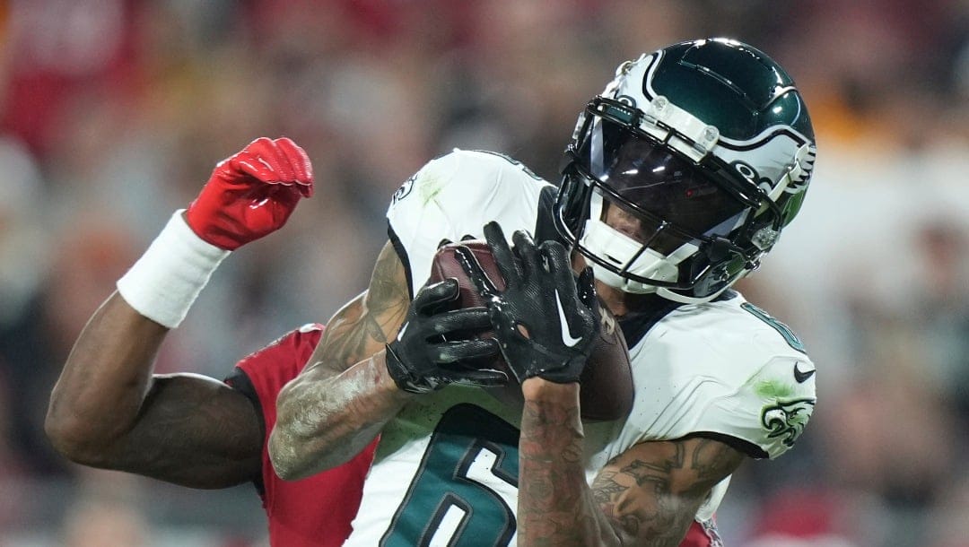 FILE - Philadelphia Eagles wide receiver DeVonta Smith (6) catches a deep pass as Tampa Bay Buccaneers cornerback Jamel Dean (35) defends during an NFL wild-card playoff football game, Monday, Jan. 15, 2024, in Tampa, Fla. The Philadelphia Eagles agreed to terms with wide receiver DeVonta Smith on a three-year contract extension through the 2028 season on Monday, April 15, 2024. (AP Photo/Peter Joneleit, File)