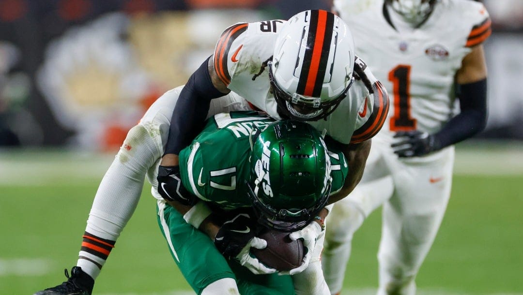 New York Jets wide receiver Garrett Wilson is tackled by Cleveland Browns cornerback Martin Emerson Jr. during the first half of an NFL football game Thursday, Dec. 28, 2023, in Cleveland. (AP Photo/Ron Schwane)