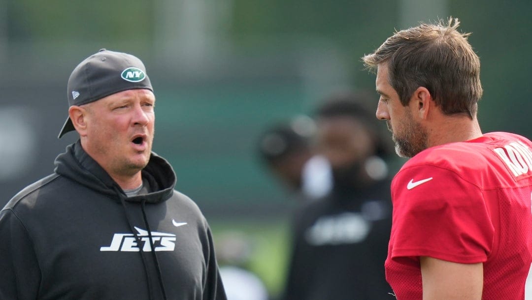 New York Jets offensive coordinator Nathaniel Hackett, left, talks with quarterback Aaron Rodgers (8) at a practice at the NFL football team's training facility in Florham Park, N.J., Tuesday, July 30, 2024. (AP Photo/Seth Wenig)