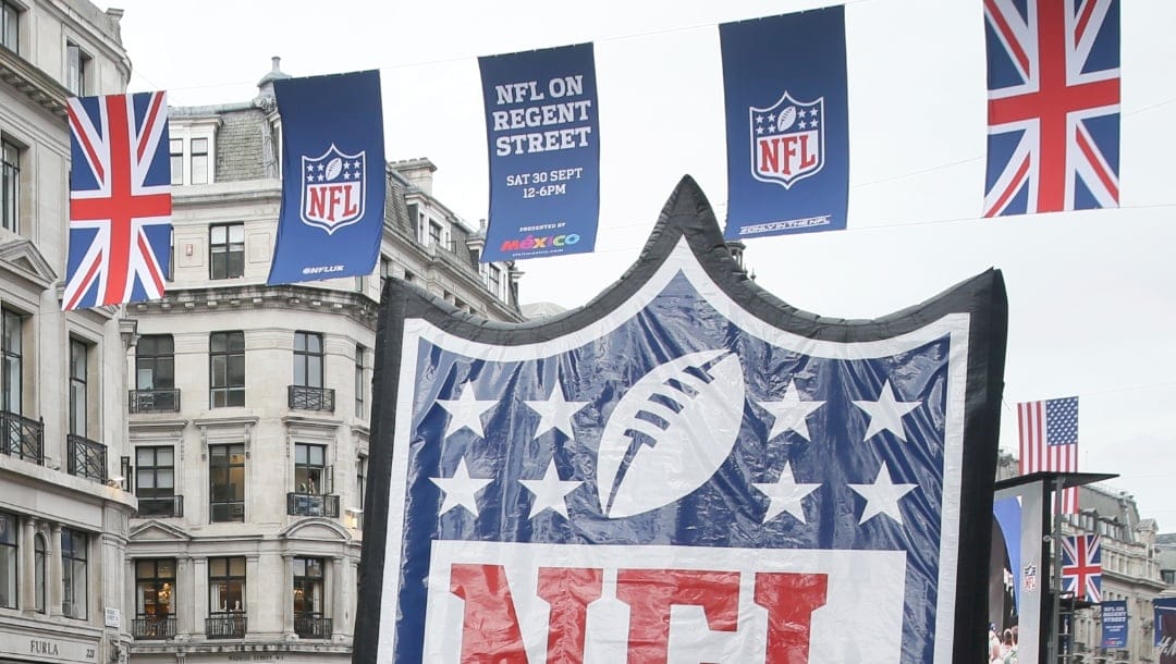 Fans queue to take pictures with the NFL logo during an NFL fan rally on Regent Street, in London, Saturday, Sept. 30, 2017. The New Orleans Saints will play the Miami Dolphins in an NFL football game at London's Wembley stadium on Sunday.