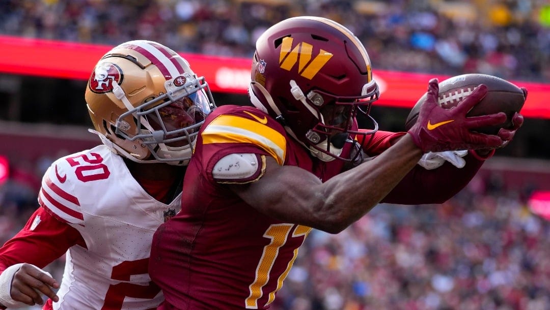 Washington Commanders wide receiver Terry McLaurin (17) making a catch to score a touchdown against San Francisco 49ers cornerback Ambry Thomas (20) during the first half of an NFL football game, Sunday, Dec. 31, 2023, in Landover, Md. (AP Photo/Alex Brandon)