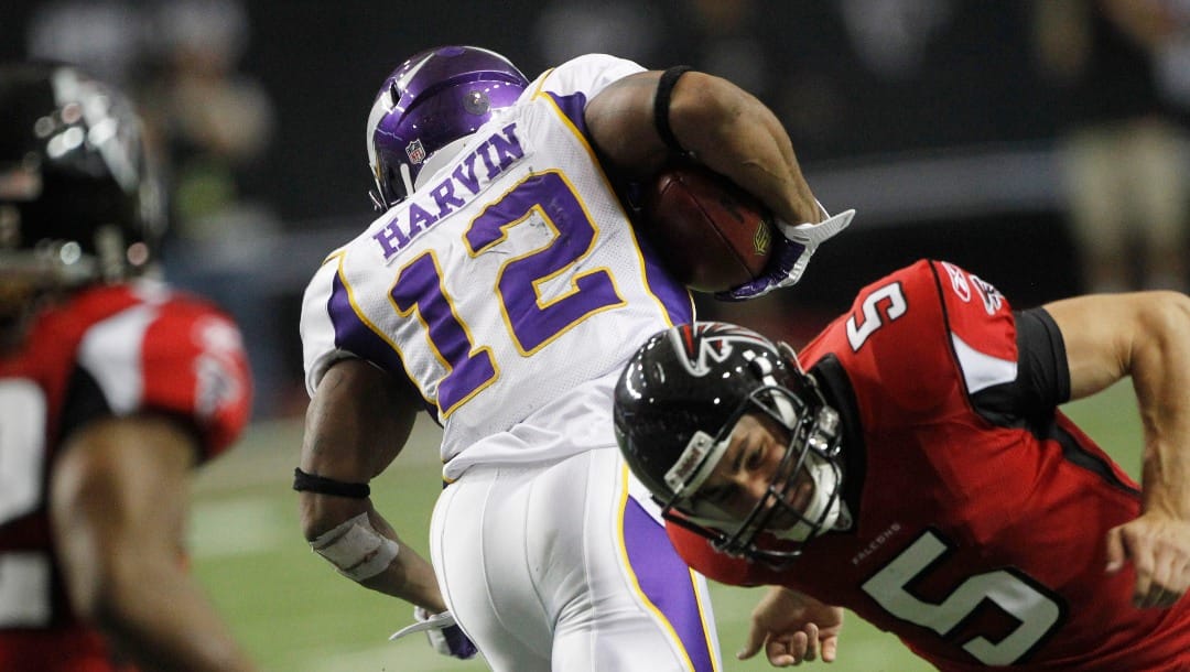 Minnesota Vikings wide receiver Percy Harvin (12) runs back a punt as Atlanta Falcons punter Matt Bosher (5) tries to tackle during the second half of an NFL football game Sunday, Nov. 27, 2011, in Atlanta. (AP Photo/John Bazemore)