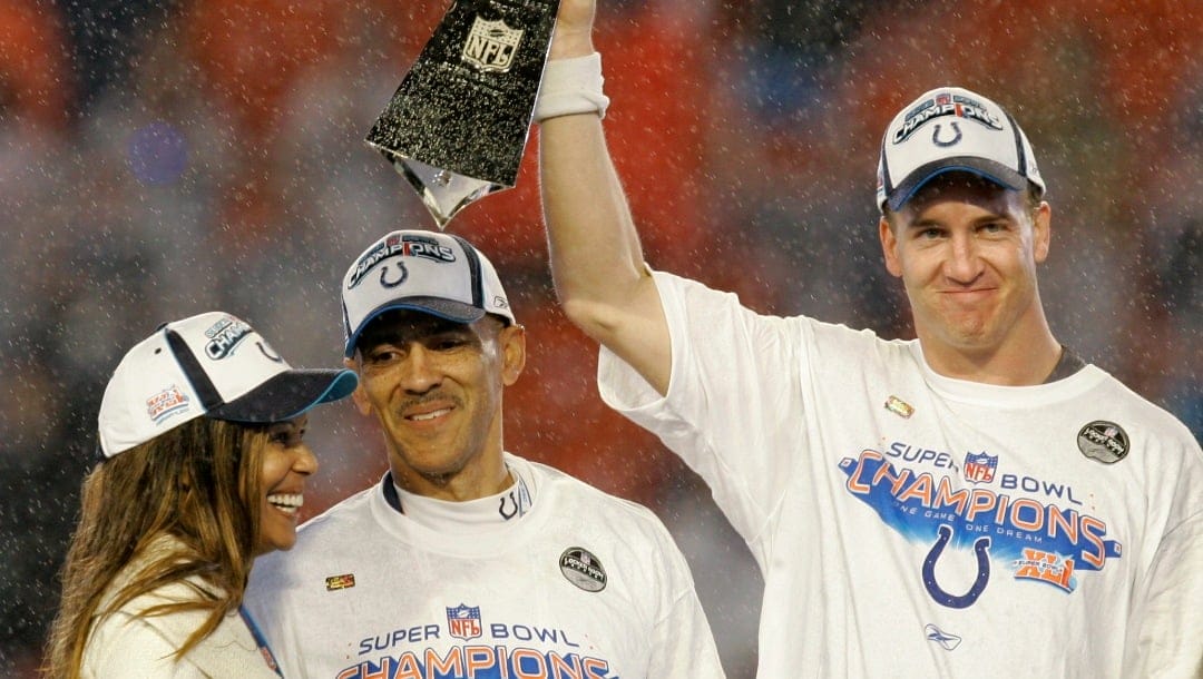 Indianapolis Colts quarterback Peyton Manning lifts the Vince Lombardi Trophy beside coach Tony Dungy and Dungy's wife, Lauren, following the Super Bowl XLI football game at Dolphin Stadium in Miami on Sunday, Feb. 4, 2007. The Colts beat the Chicago Bears 29-17.