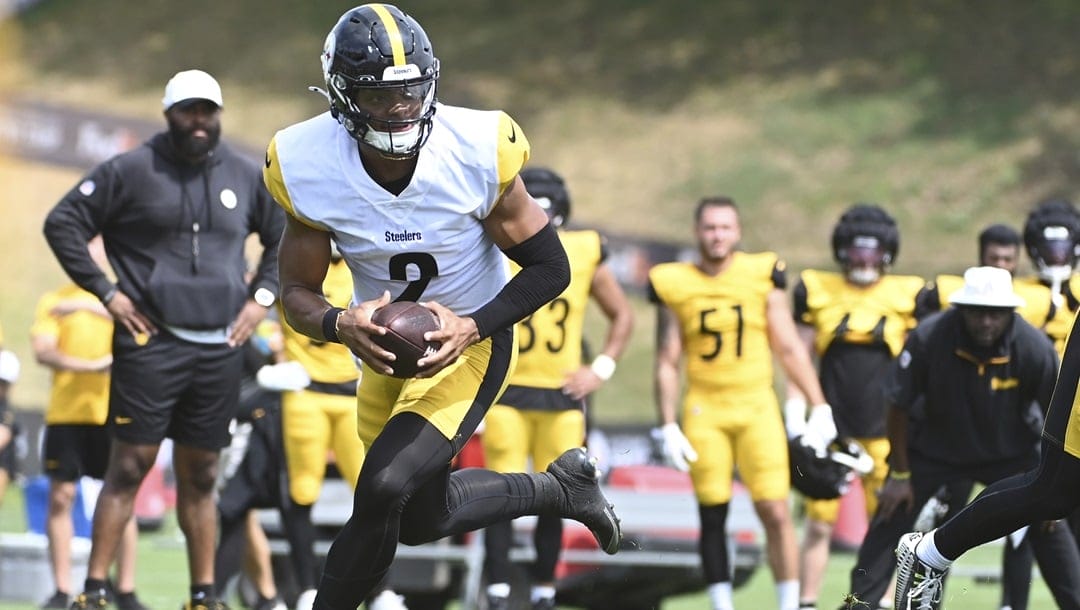 Pittsburgh Steelers quarterback Justin Fields, scrambles out of the pocket during the NFL football team's training camp in Latrobe, Pa., Tuesday, July 30, 2024.