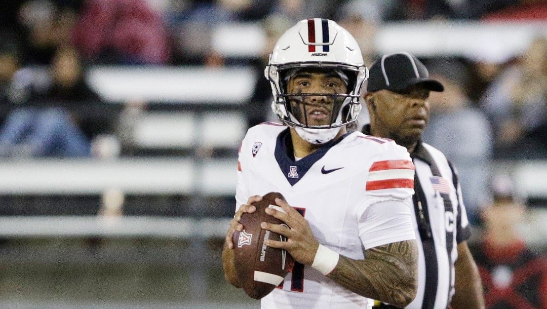 Arizona quarterback Noah Fifita looks for a receiver during the second half of an NCAA college football game against Washington State, Saturday, Oct. 14, 2023, in Pullman, Wash. (AP Photo/Young Kwak)