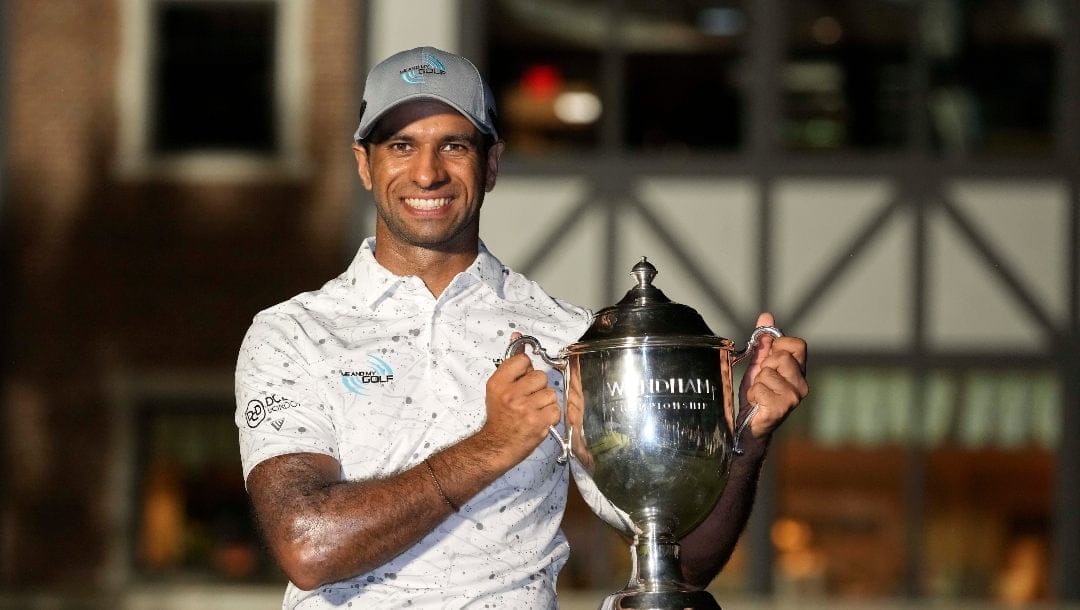 Aaron Rai, of England, poses with the trophy after winning the Wyndham Championship golf tournament in Greensboro, N.C., Sunday, Aug. 11, 2024.