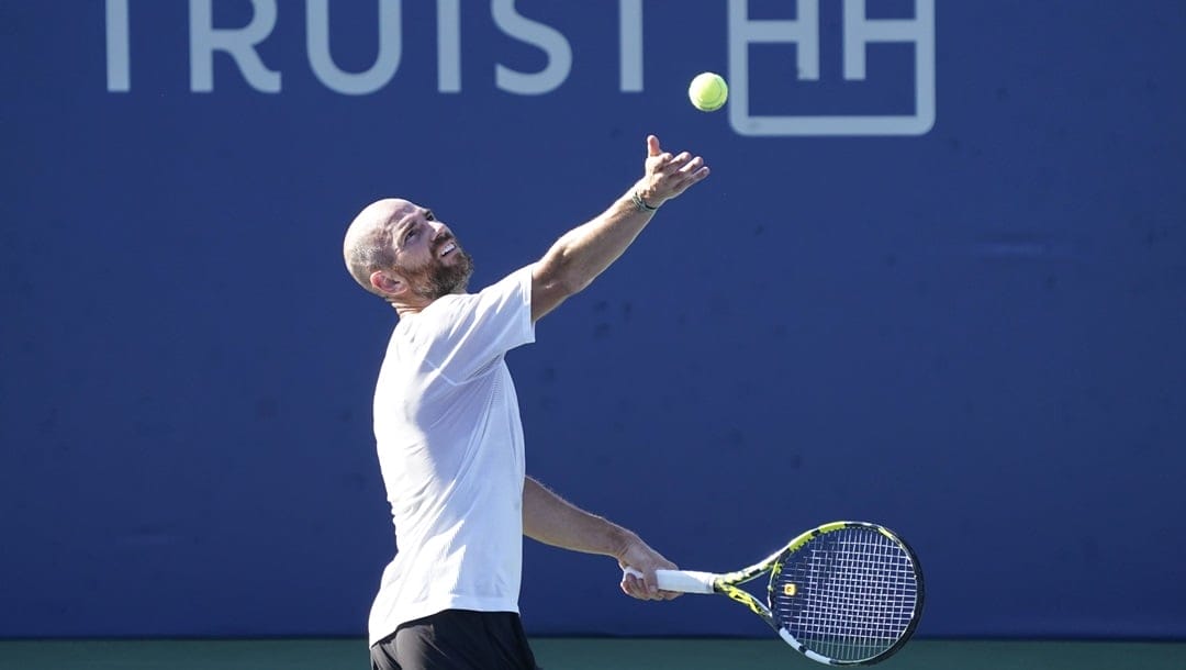 Adrian Mannarino, of France, serves against Laslo Djere, of Serbia, during the championship match of the Winston-Salem Open tennis tournament in Winston-Salem, N.C., Saturday, Aug. 27, 2022.