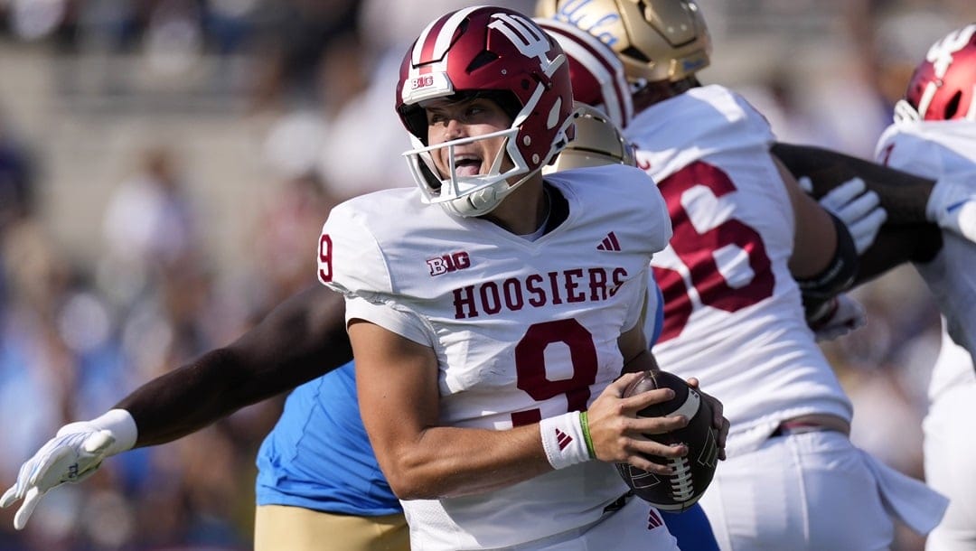 Indiana quarterback Kurtis Rourke avoids a tackles as he rolls out during the first half of an NCAA college football game against UCLA, Saturday, Sept. 14, 2024, in Pasadena, Calif.