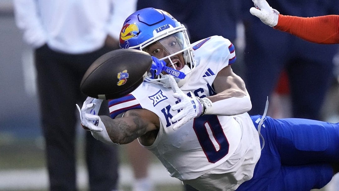 Kansas wide receiver Quentin Skinner is unable to catch a pass from quarterback Jalon Daniels as Illinois defensive back Torrie Cox Jr. defends during the first half of an NCAA college football game Saturday, Sept. 7, 2024, in Champaign, Ill.