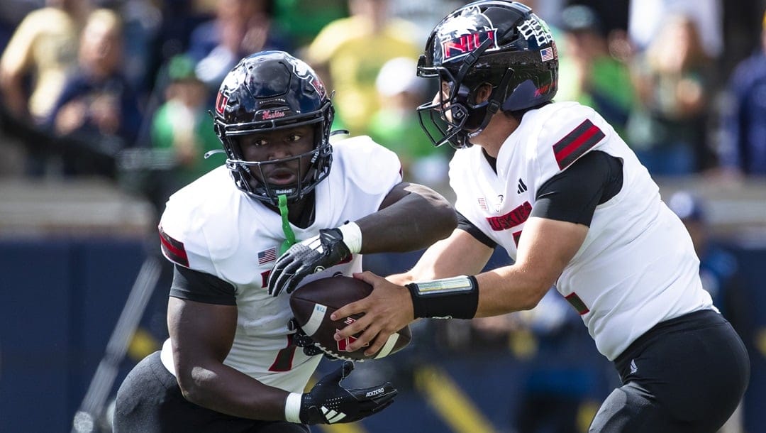 Northern Illinois quarterback Ethan Hampton (2) fakes a hand off to Northern Illinois running back Antario Brown (1) during the first half of an NCAA college football game against Notre Dame, Saturday, Sept. 7, 2024, in South Bend, Ind.