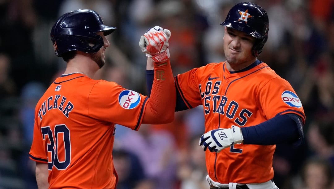 Houston Astros' Alex Bregman, right, celebrates with Kyle Tucker, left, after hitting a two-run home run during the third inning of a baseball game against the Los Angeles Angels, Friday, Sept. 20, 2024, in Houston.