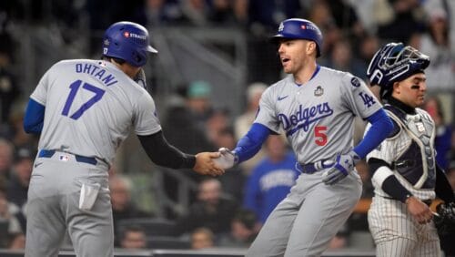 Los Angeles Dodgers' Freddie Freeman (5) celebrates with Shohei Ohtani (17) after both scored on Freeman's two-run home run against the New York Yankees during the first inning in Game 3 of the baseball World Series, Monday, Oct. 28, 2024, in New York.