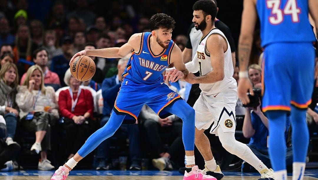 Chet Holmgren #7 of the Oklahoma City Thunder looks to back down Jamal Murray #27 of the Denver Nuggets during the second half at Paycom Center on January 31, 2024 in Oklahoma City, Oklahoma.