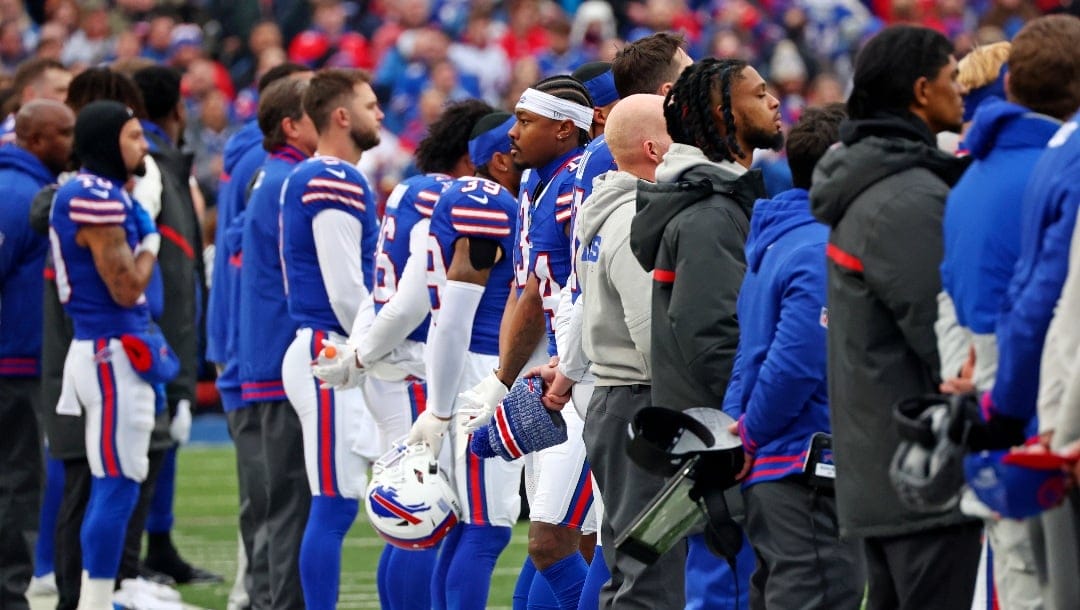 Buffalo Bills wide receiver Stefon Diggs, center, and teammates stand for the National Anthem before an NFL football game against the New England Patriots in Orchard Park, N.Y., Sunday, Dec. 31, 2023. (AP Photo/Jeffrey T. Barnes )