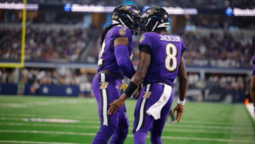 Baltimore Ravens' Lamar Jackson (8) and Derrick Henry, left, celebrate Jackson's rushing touchdown during an NFL football game against the Dallas Cowboys, Sunday, Sept. 22, 2024 in Arlington, Texas. The Ravens defeated the Cowboys, 28-25.