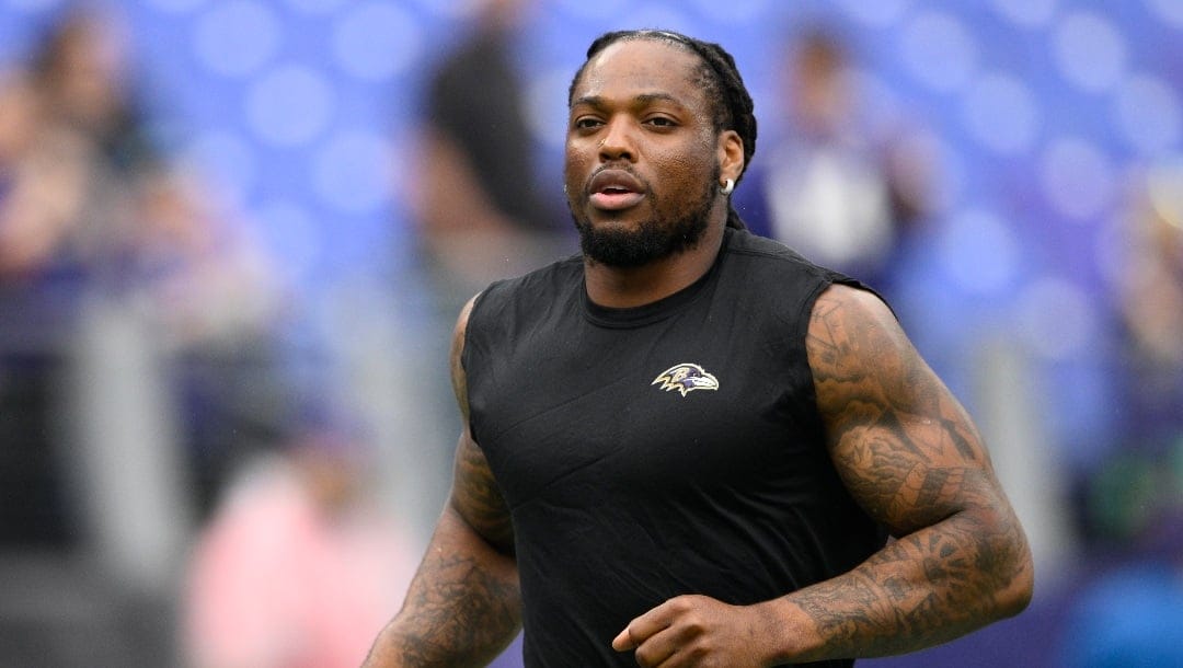 Baltimore Ravens running back Derrick Henry (22) works out before an NFL preseason football game against the Atlanta Falcons, Saturday, August 17, 2024, in Baltimore. (AP Photo/Nick Wass)