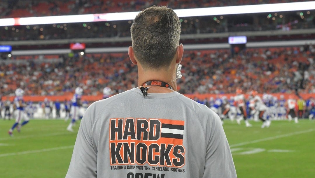 A crew member of the HBO series Hard Knocks stands on the sideline during an NFL football preseason game between the Cleveland Browns and the Buffalo Bills, Friday, Aug. 17, 2018, in Cleveland. Buffalo won 19-17.