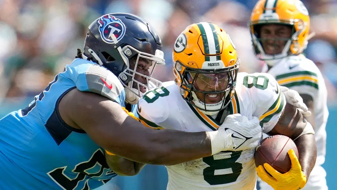 Green Bay Packers' Josh Jacobs tries to get past Tennessee Titans' T'Vondre Sweat during the second half of an NFL football game Sunday, Sept. 22, 2024, in Nashville, Tenn. (AP Photo/George Walker IV)