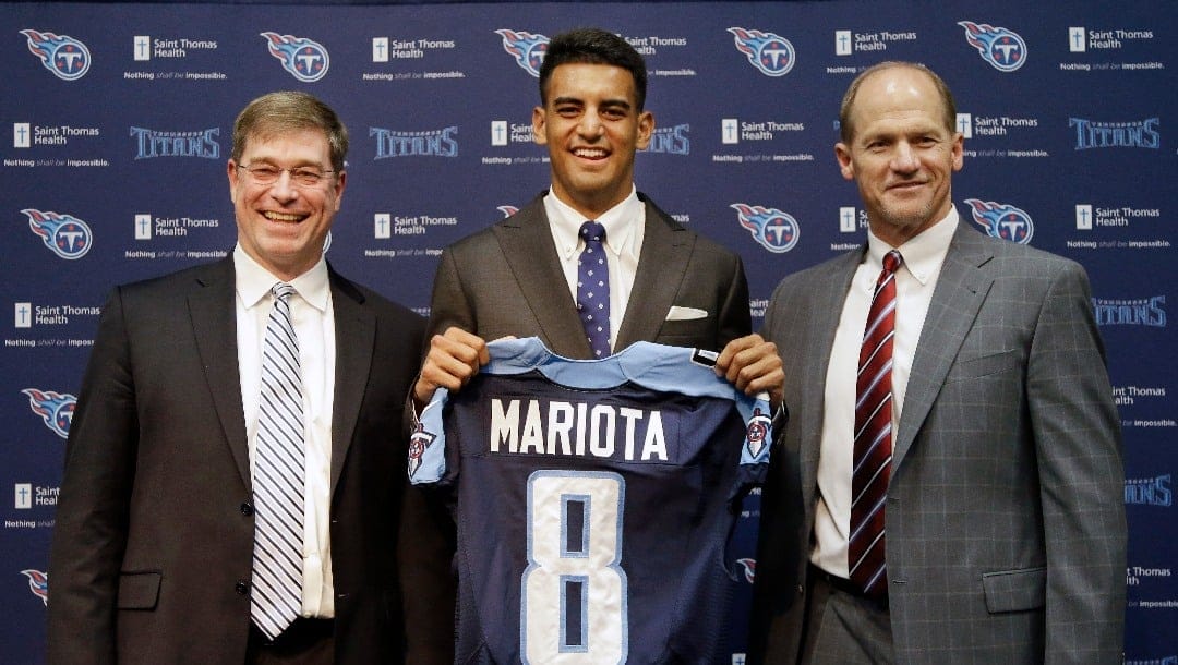 Marcus Mariota, center, former Oregon quarterback and overall No. 2 NFL football draft pick by the Tennessee Titans, poses with head coach Ken Whisenhunt, right, and general manager Ruston Webster, left, during a news conference Friday, May 1, 2015, in Nashville, Tenn. Mariota was selected by the Titans in the first round Thursday.