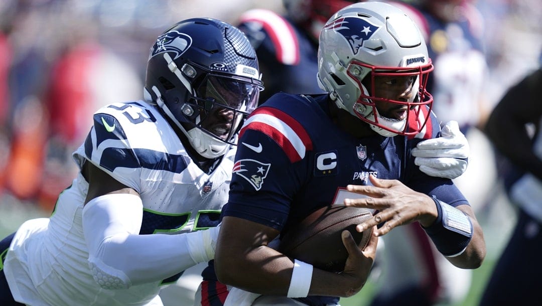 Seattle Seahawks linebacker Boye Mafe (53) chases New England Patriots quarterback Jacoby Brissett, right, during an NFL football game, Sunday, Sept. 15, 2024, in Foxborough, Mass.