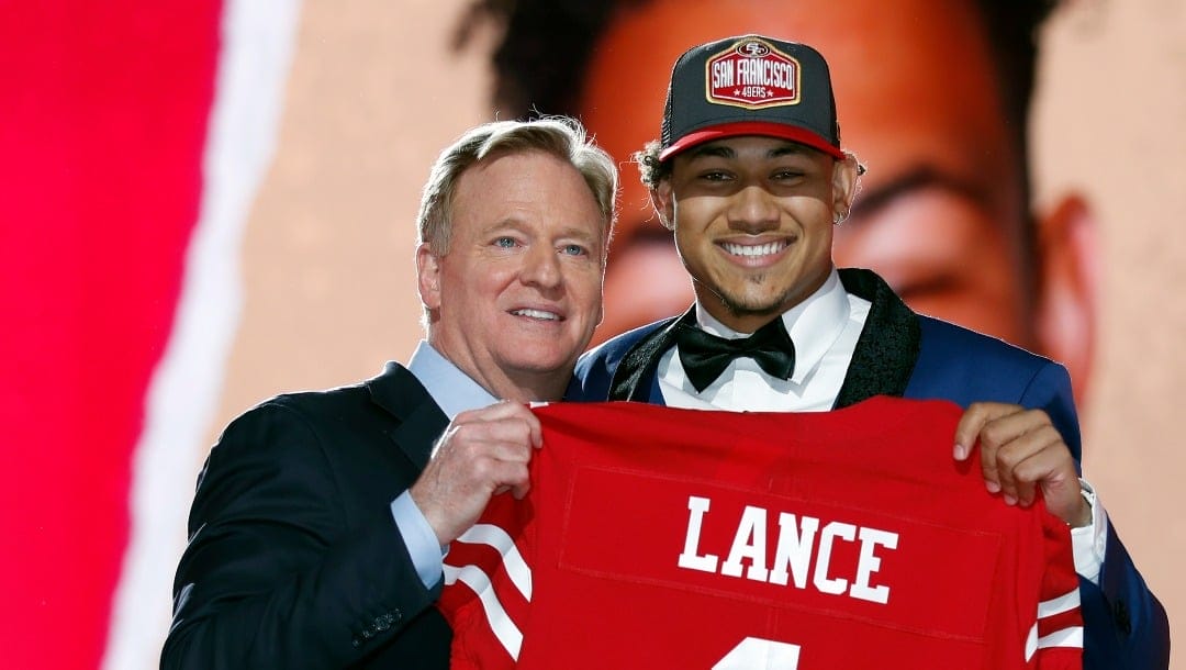 North Dakota State quarterback Trey Lance, right, holds a jersey with NFL Commissioner Roger Goodell after being chosen by the San Francisco 49ers with the third pick in the first round of the NFL football draft Thursday April 29, 2021, in Cleveland.