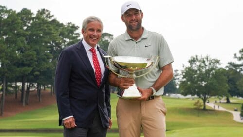 PGA TOUR Commissioner Jay Monahan poses with Scottie Scheffler with the FedExCup Trophy after Scheffler won the final round of the Tour Championship golf tournament, Sunday, Sept. 1, 2024, in Atlanta.