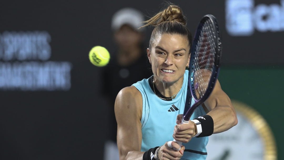 Maria Sakkari, of Greece, returns a shot to Caroline Garcia, of France, during semifinal match at the Guadalajara Open tennis tournament in Guadalajara, Mexico, Friday, Sept. 22, 2023.