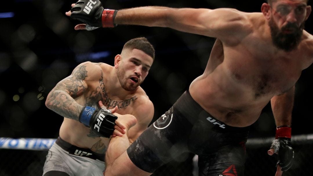 Sean Brady, left, takes a foot to the chest from Court McGee during a welterweight mixed martial arts bout Friday, Oct. 18, 2019.