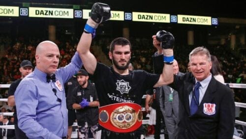 Artur Beterbiev, center, celebrates after defeating Callum Johnson during the IBF light heavyweight title boxing match.