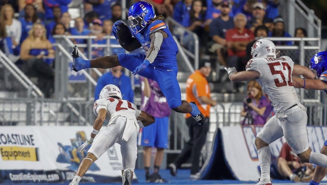 Boise State running back Ashton Jeanty (2) hurdles Washington State defensive back Ethan O'Connor (24) on a run in the second quarter of an NCAA college football game, Saturday, Sept. 28, 2024, in Boise, Idaho.