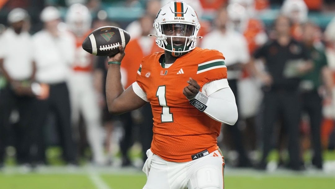 Miami quarterback Cam Ward (1) aims a pass during the first half of an NCAA college football game against Virginia Tech , Friday, Sept. 27, 2024, in Miami Gardens, Fla.